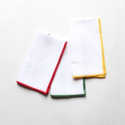 White linen dinner napkin with red or green or yellow color border